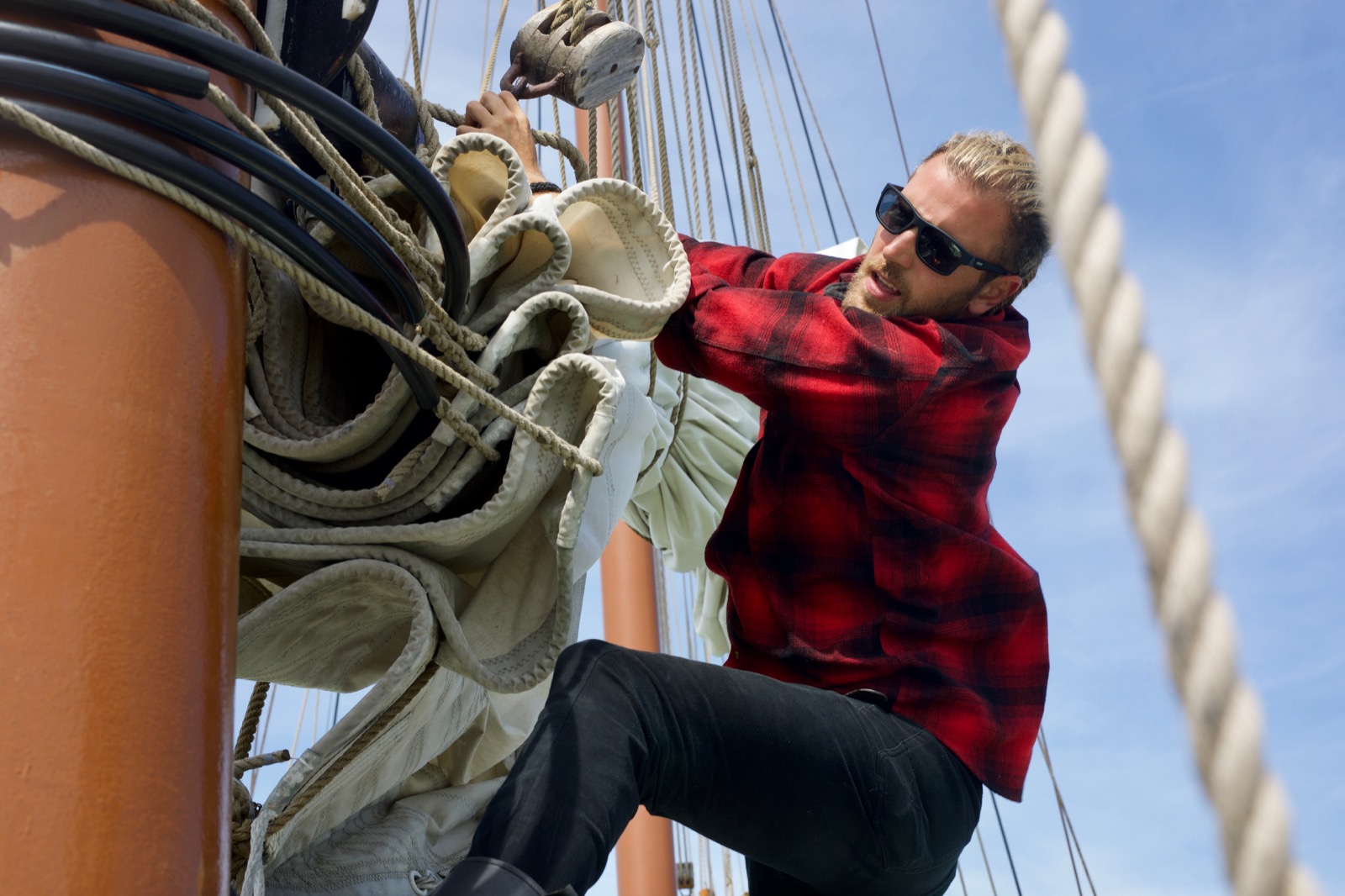 Fabio Andreatta climbing rigging on a traditional sailing ship