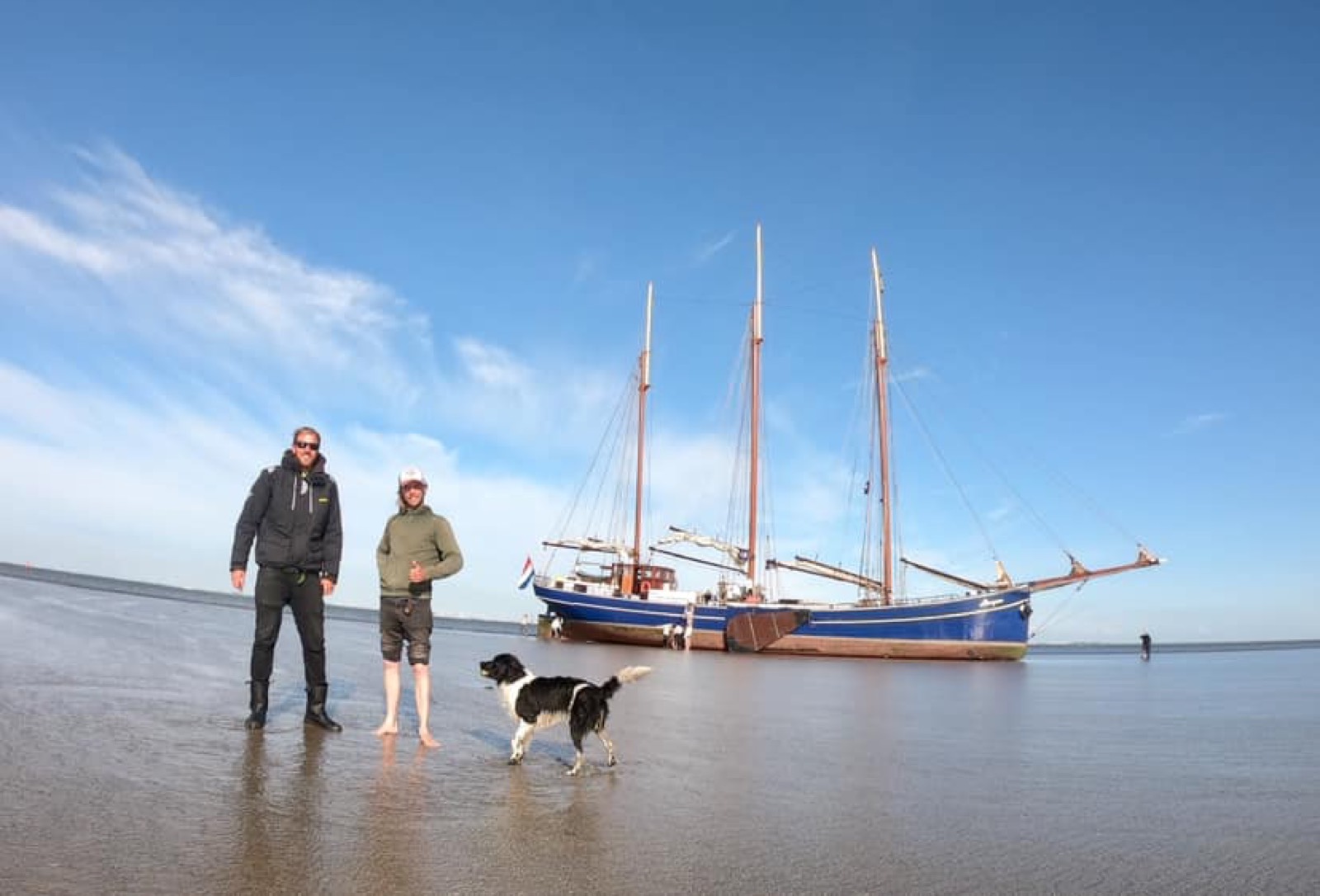 Traditional sailing ship on a beach with Fabio Andreatta and his sailing dog
