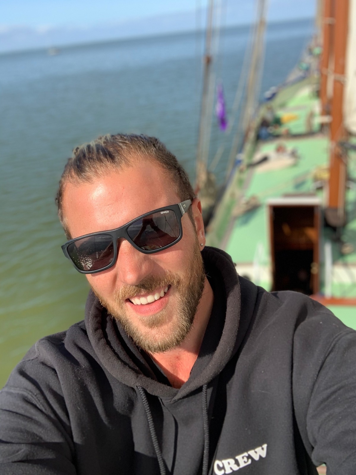 Fabio Andreatta crew selfie with sailing ship rigging in the background
