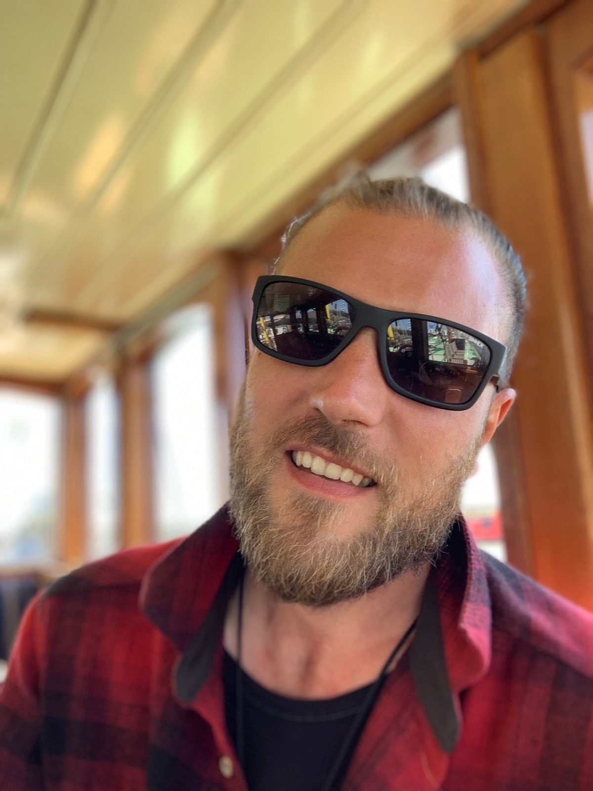 Fabio Andreatta smiling in a ship cabin on a sunny sailing day