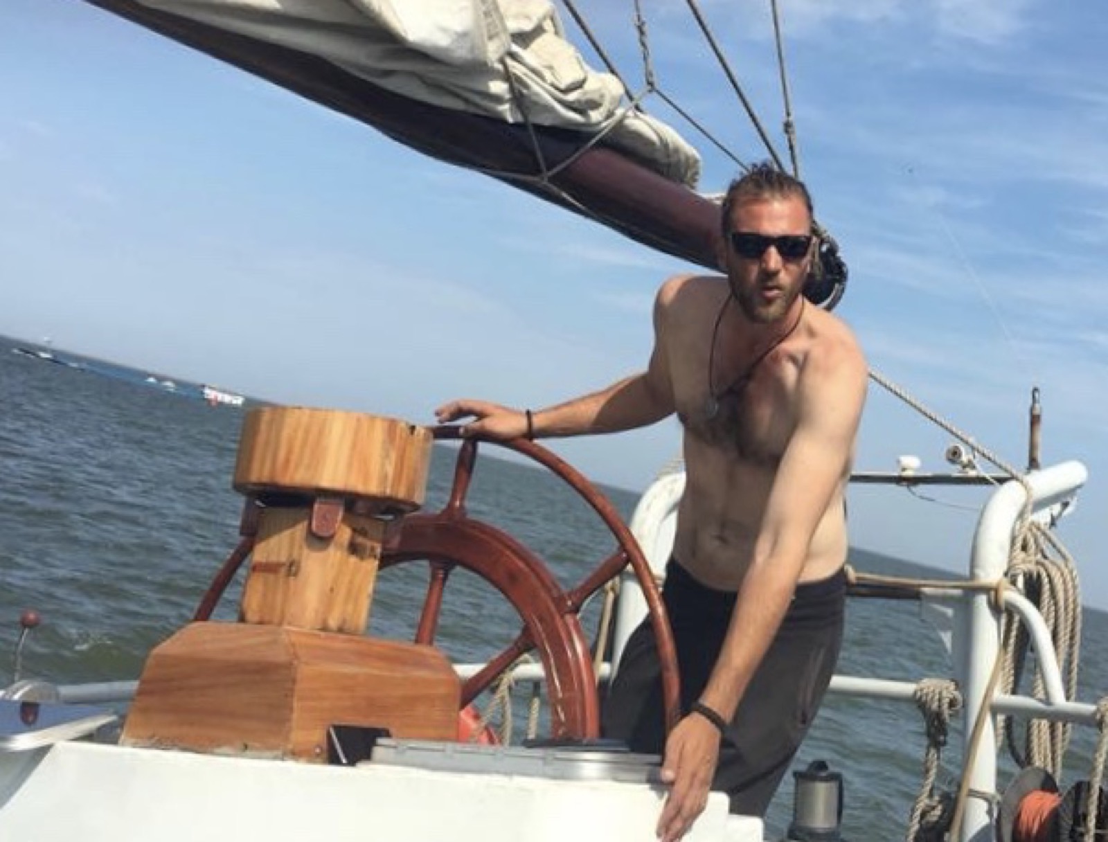 Fabio Andreatta at the ship's wheel on a sunny sailing day
