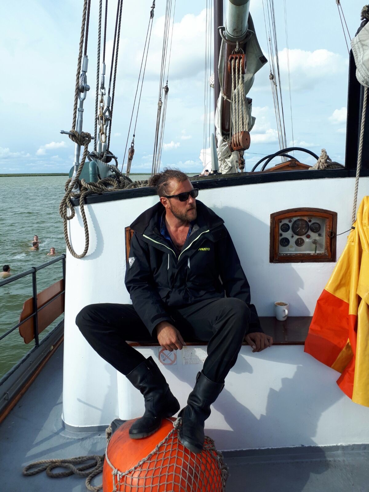 Fabio Andreatta sitting on deck in sailing gear and sea boots