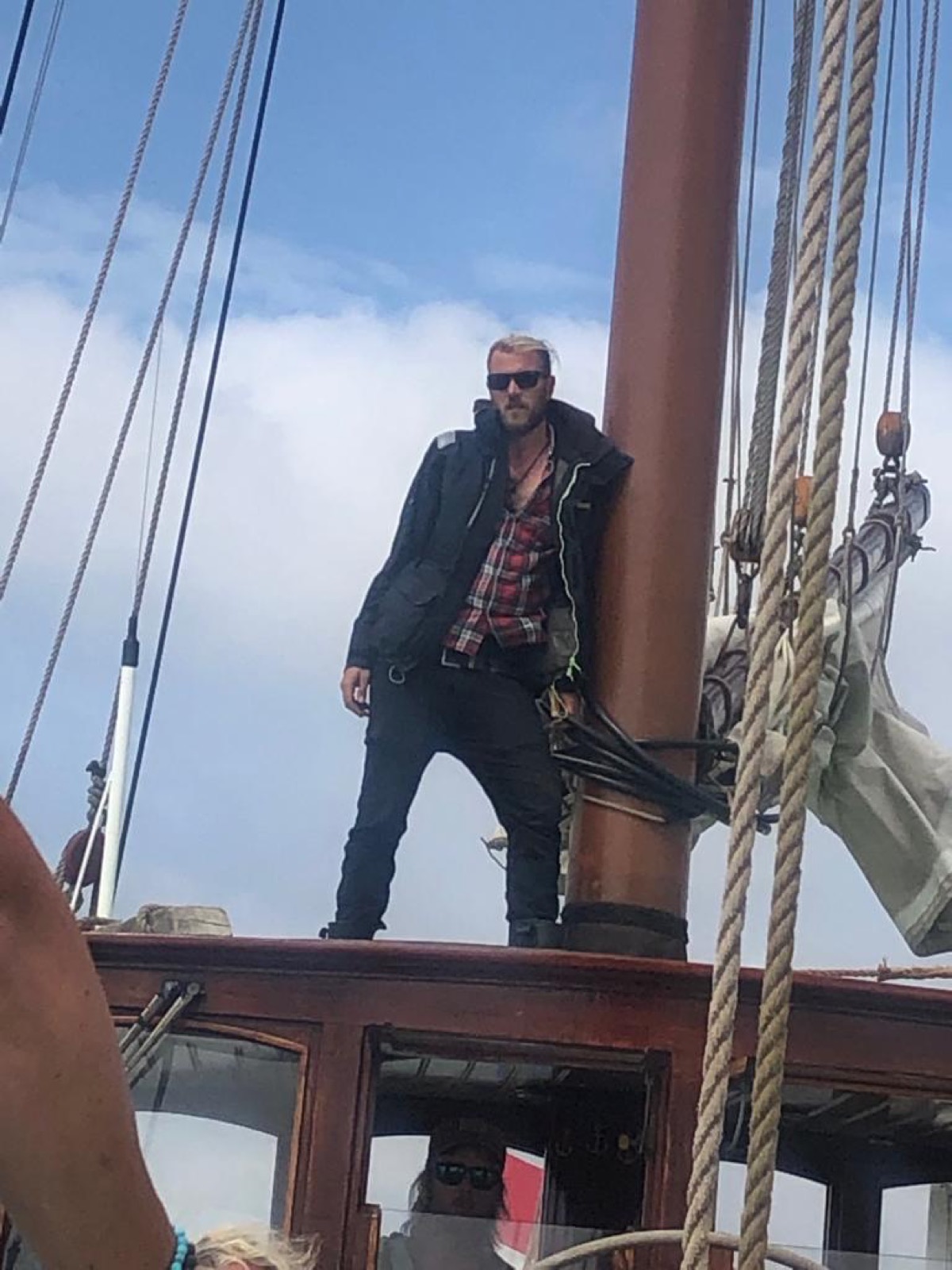 Fabio Andreatta standing by the mast on a traditional tall ship